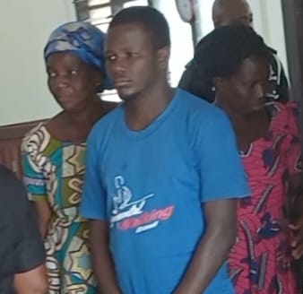 Newell Gavu (middle) being aided to court some family members